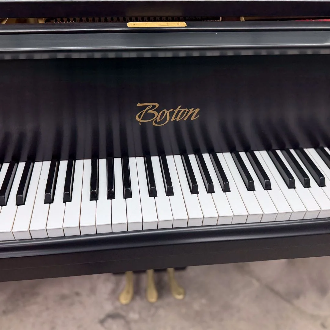 Angled view along the Boston keyboard and the gold script decal